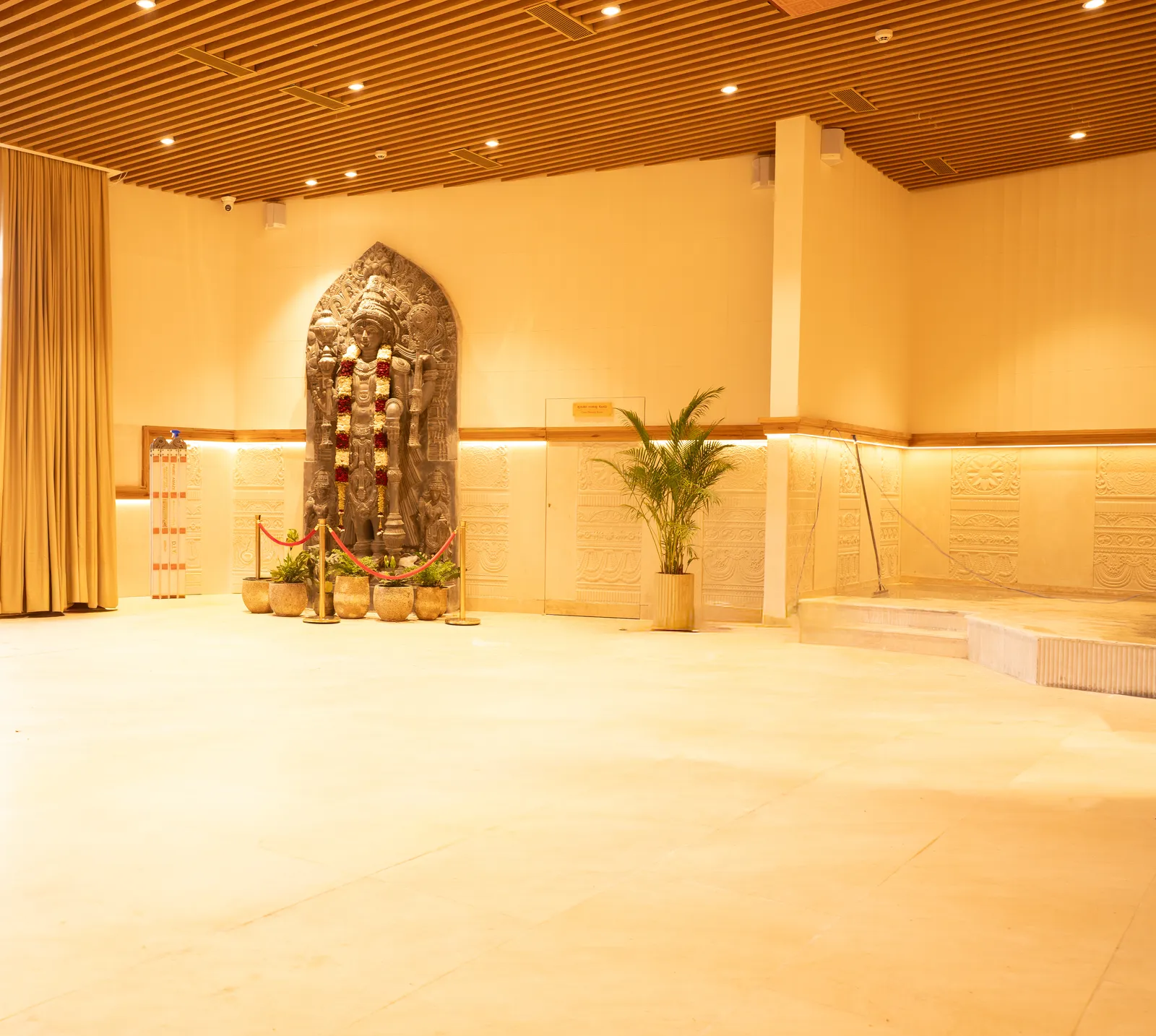 Banquet hall with carved stone idol niche — Chalukya Samrat